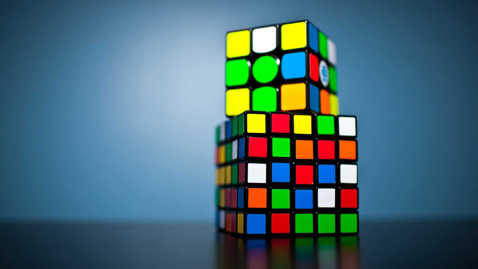 two Rubik's Cubes with one on top of the other at a slight angle